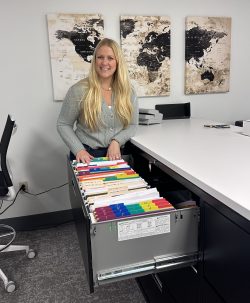 An employee of Illinois Registered Office looks through a color-coded filing cabinet at our office in Springfield.