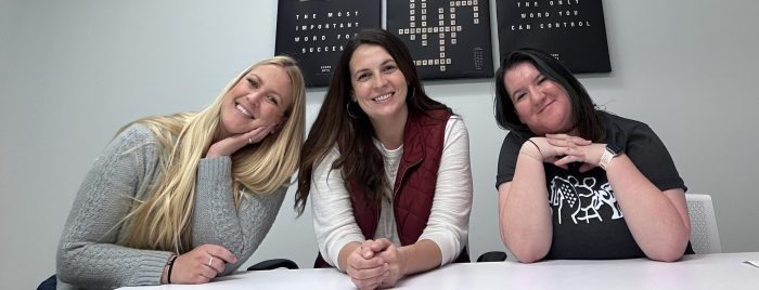 Three employees of Illinois Registered Office sit at a table in the office in Springfield.