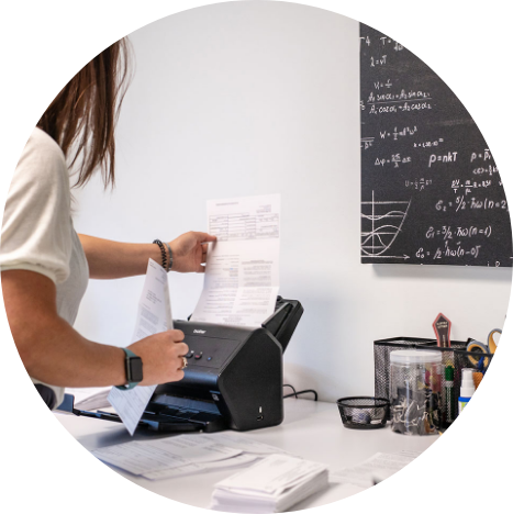 A woman scans a document at a desk