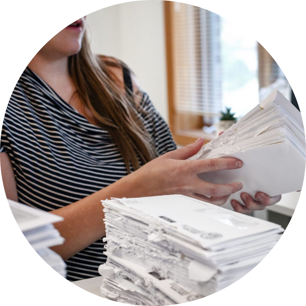 A woman sorts envelopes at Illinois Registered Office