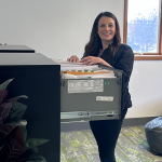 A registered agent at Illinois Registered Office putting a document in a filing cabinet.