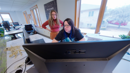 Two of our filers working at a computer.