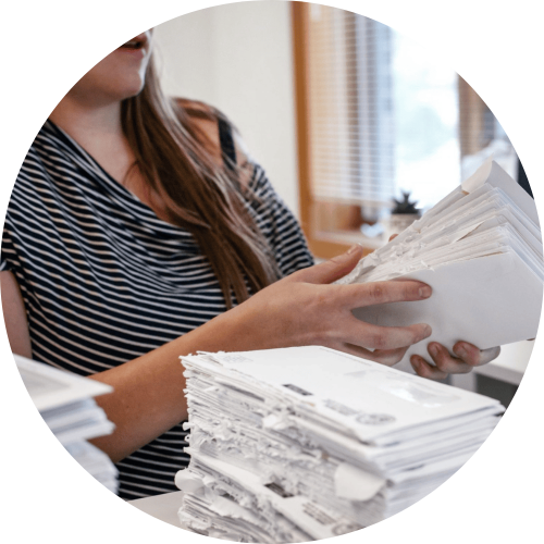 Woman stacking a pile of envelopes.