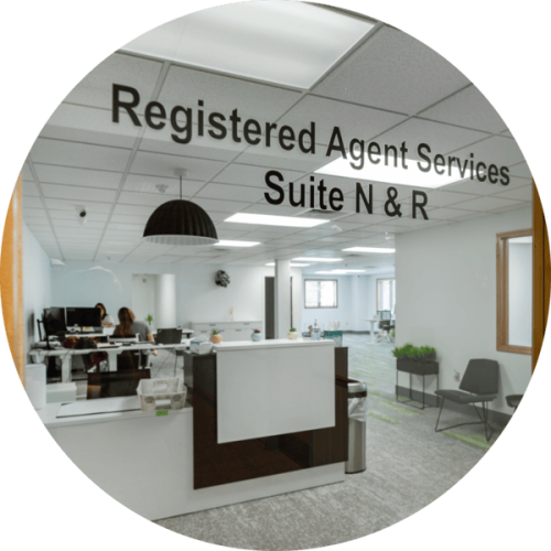 A window into an office with the words "Registered Agent Services Suite N & R"
